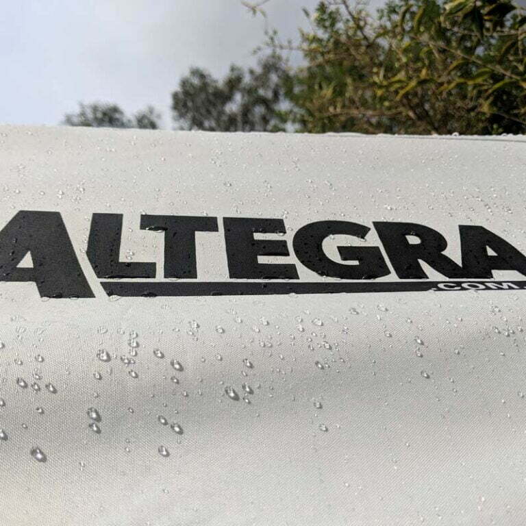 An image of the Altegra Elite canopy in white in the rain with water droplets running off the waterproof surface - our high-quality PVC-lined Polyester in a thick 330GSM weight keeps heavy rain out of your gazebo for the long-term.