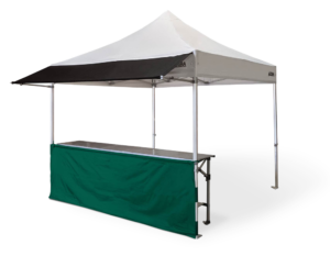 Altegra 3x3m aluminium gazebo with white canopy, attached black 3m gazebo awning, and green gazebo half wall kit paired with the robust 3m folding aluminium table.