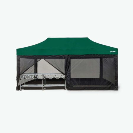 An image of the Altegra 3x6m marquee with green canopy, fitted out with our 3x6m mesh wall kit and complemented by the 3m folding table for entertaining. Our 4x 3m solid mesh walls and 2x 3m mesh zip walls create an accessible, bug, fly, and mosquito-free internal marquee haven.