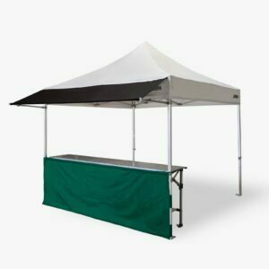 Altegra structured 3m half wall in green connected to our Heavy Duty 3x3m gazebo, fitted with our 3m awning, and complete with a 3m folding table - a perfect exhibitor's tent, display stand, or market stall.