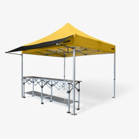Altegra 3m Gazebo Awning in black attached to a 3x3m Heavy Duty gazebo with yellow canopy and paired with a 3m aluminium folding table - a perfect market stall, exhibitor stand, or entertaining tent starter kit. Black gazebo awning.